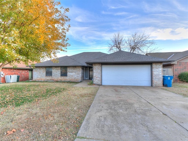 single story home with a garage and a front lawn