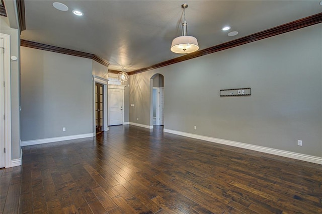 spare room featuring dark hardwood / wood-style flooring and ornamental molding