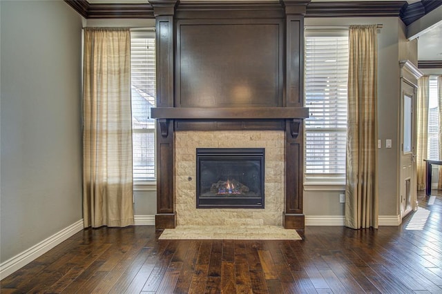 unfurnished living room with crown molding, dark hardwood / wood-style flooring, and a fireplace