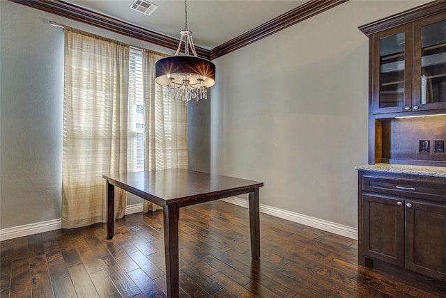 unfurnished dining area featuring an inviting chandelier, dark hardwood / wood-style floors, and ornamental molding