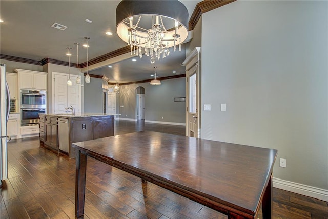 dining space with dark hardwood / wood-style flooring, a chandelier, and ornamental molding