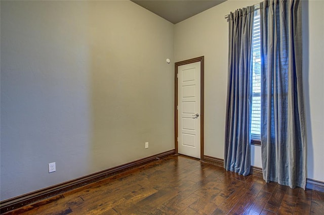 spare room with dark wood-type flooring