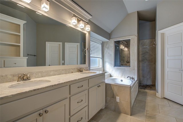 bathroom featuring tile patterned flooring, shower with separate bathtub, vanity, and vaulted ceiling