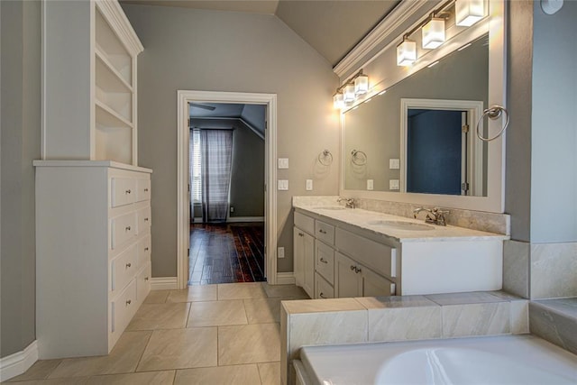 bathroom featuring a tub to relax in, vanity, hardwood / wood-style flooring, and lofted ceiling