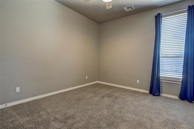 carpeted empty room featuring ceiling fan