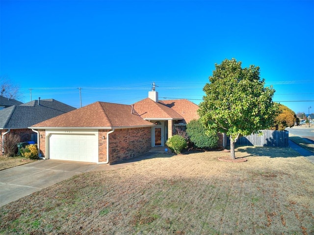 ranch-style home with a front lawn and a garage