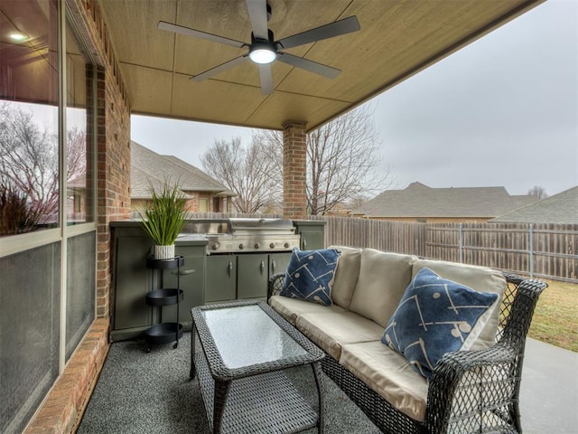 view of patio / terrace with grilling area, ceiling fan, and exterior kitchen