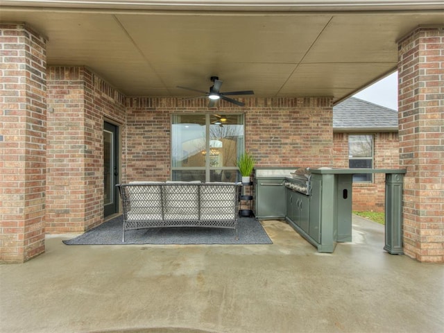 view of patio / terrace with ceiling fan, a grill, and exterior kitchen