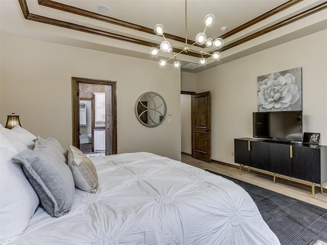 bedroom featuring an inviting chandelier, ornamental molding, a tray ceiling, and wood-type flooring