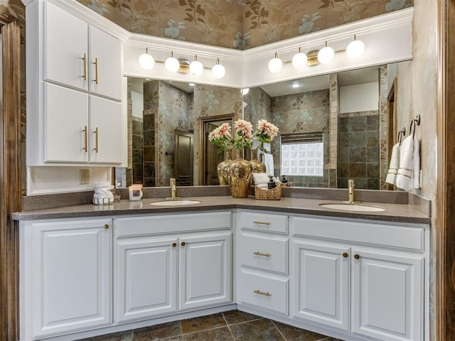 bathroom with tiled shower and vanity