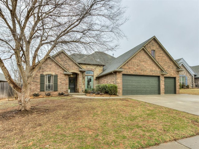 view of front of home featuring a garage, brick siding, a shingled roof, driveway, and a front lawn