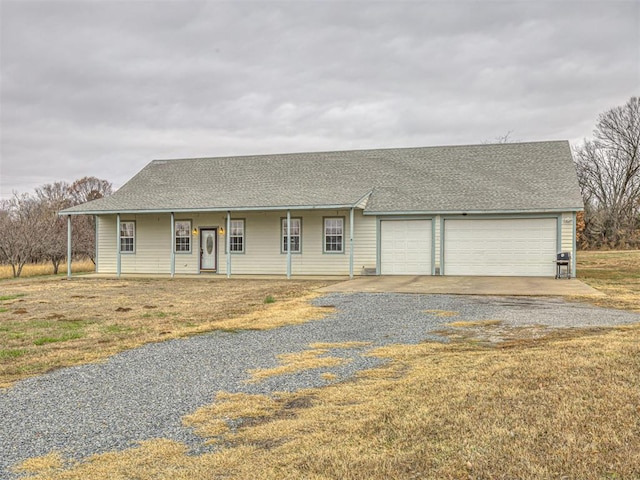 single story home featuring a porch and a garage