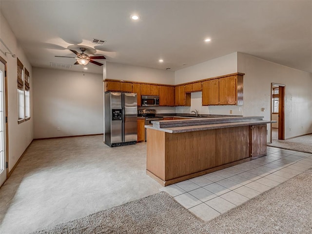 kitchen featuring ceiling fan, sink, light tile patterned floors, and stainless steel appliances