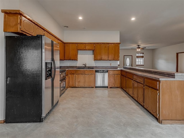 kitchen featuring ceiling fan, sink, kitchen peninsula, and stainless steel appliances