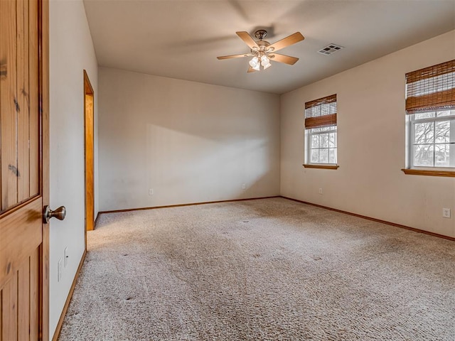 spare room featuring ceiling fan and light carpet