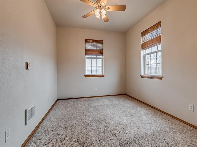 unfurnished room with carpet, ceiling fan, and a healthy amount of sunlight