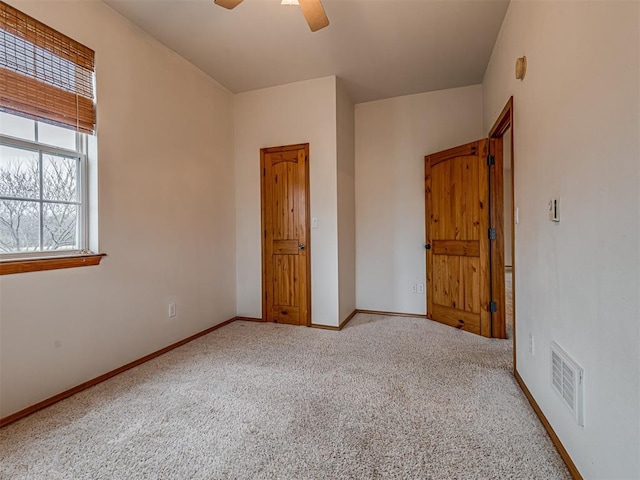 unfurnished bedroom featuring carpet flooring and ceiling fan