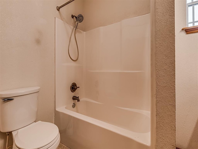 bathroom with toilet and shower / bathtub combination