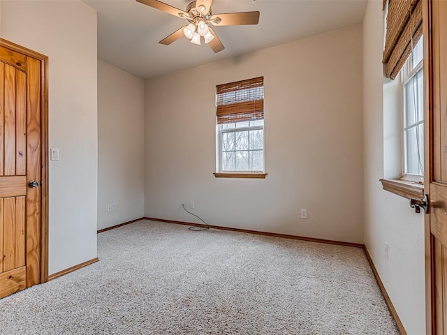 spare room with ceiling fan, a healthy amount of sunlight, and carpet floors