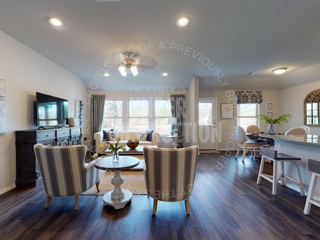 living room with ceiling fan and dark wood-type flooring