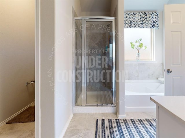 bathroom with tile patterned flooring, vanity, and shower with separate bathtub