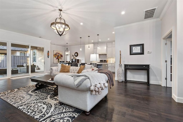 living room featuring ornamental molding, dark wood-type flooring, and a notable chandelier