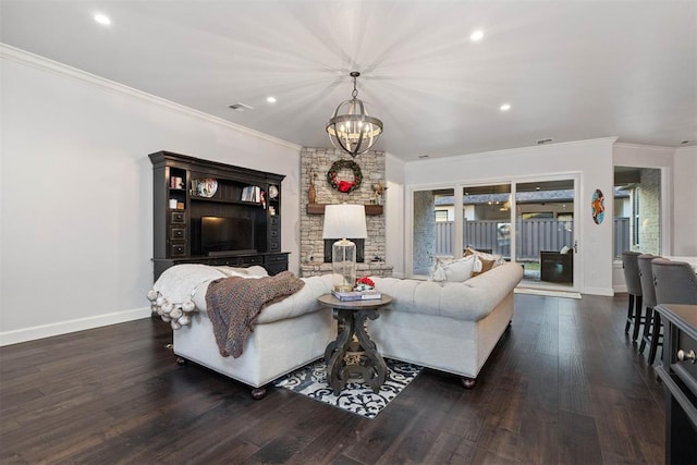 living room with dark wood-type flooring, ornamental molding, and a fireplace