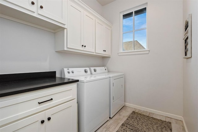 washroom featuring cabinets and independent washer and dryer