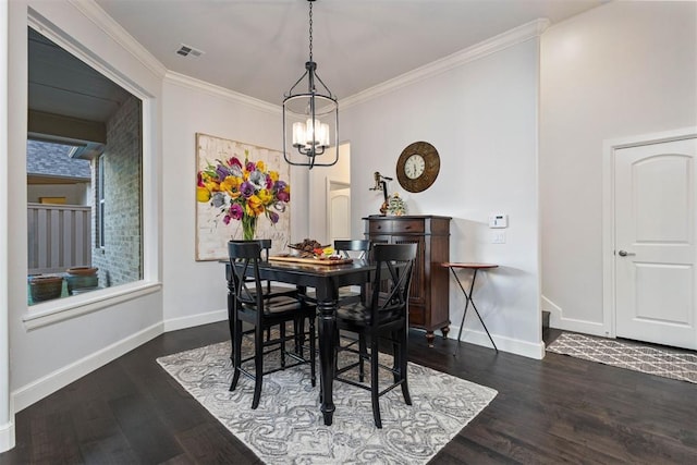 dining area with crown molding, dark wood-type flooring, and a chandelier