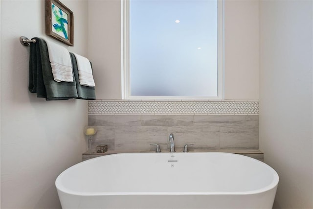 bathroom with a tub to relax in