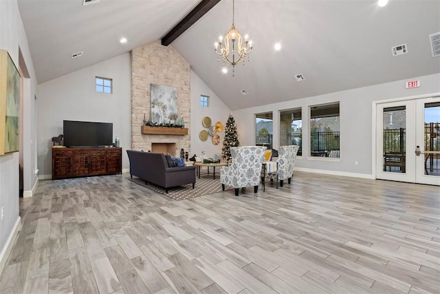 living room with a stone fireplace, french doors, and light wood-type flooring