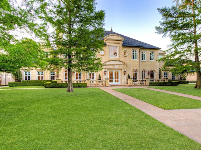 view of front of property with a front yard and french doors