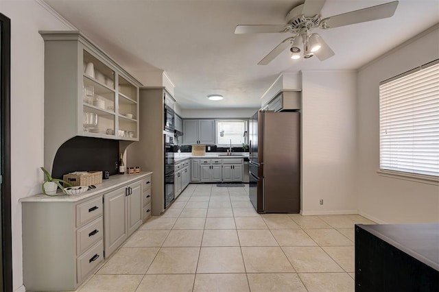 kitchen with gray cabinetry, sink, ceiling fan, stainless steel fridge, and light tile patterned floors