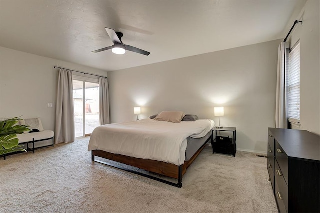 carpeted bedroom with ceiling fan and access to outside