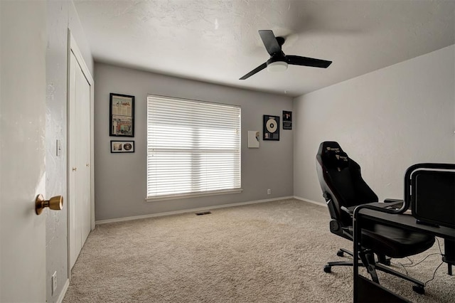 home office featuring ceiling fan and light carpet