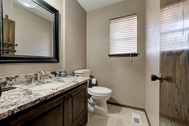 bathroom with tile patterned floors, vanity, and toilet