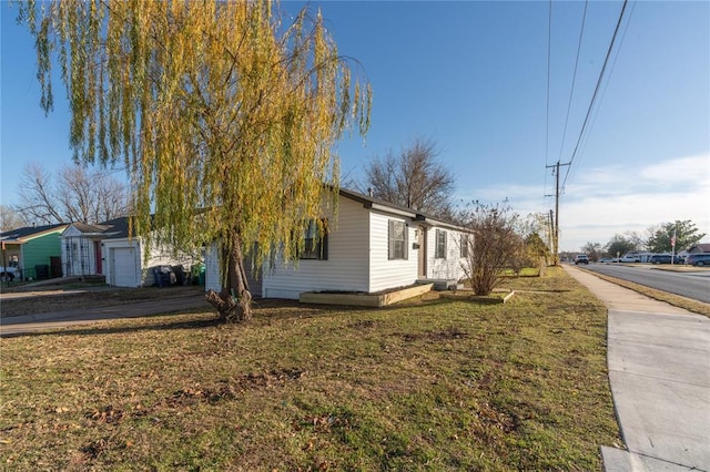 view of side of home with a yard