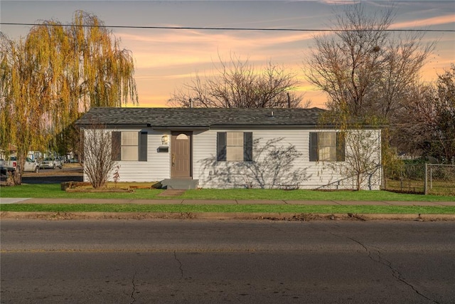 ranch-style house featuring a lawn