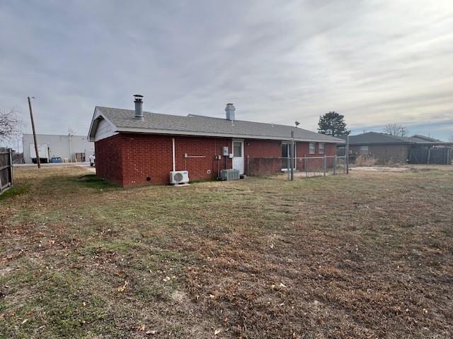 rear view of property with a lawn