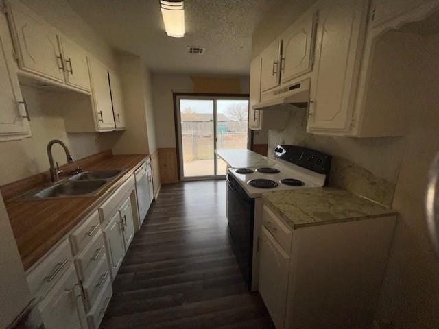 kitchen with sink, dark hardwood / wood-style floors, a textured ceiling, white appliances, and white cabinets