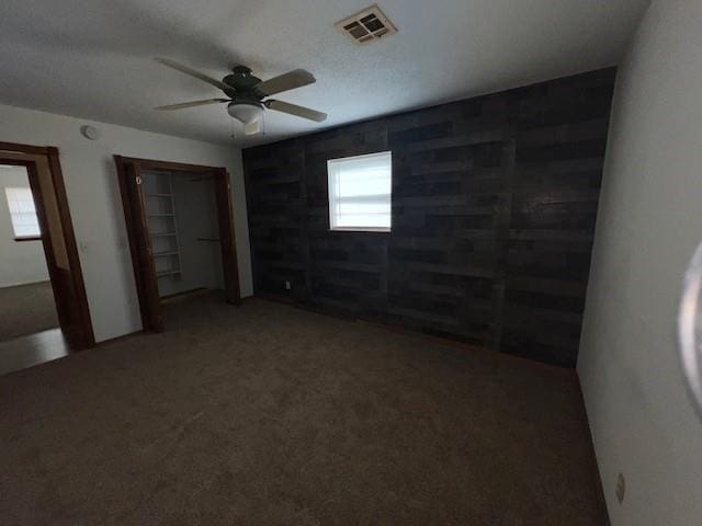 unfurnished bedroom featuring carpet and ceiling fan