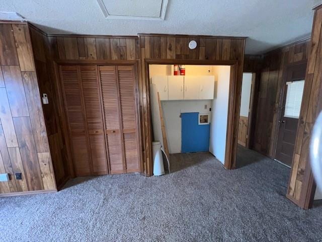 unfurnished bedroom featuring wood walls and a closet