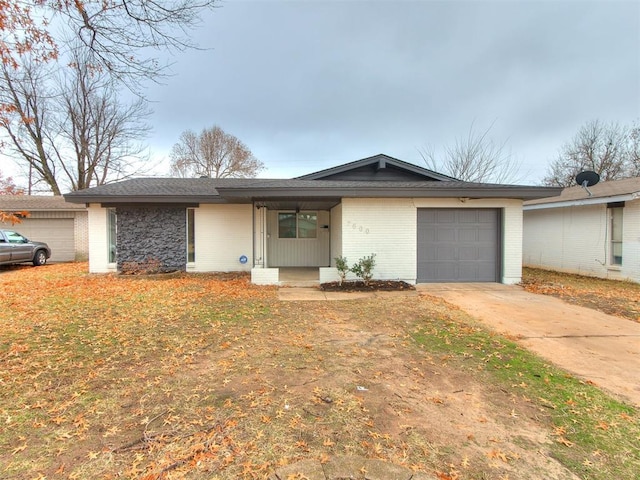 ranch-style house with covered porch and a garage