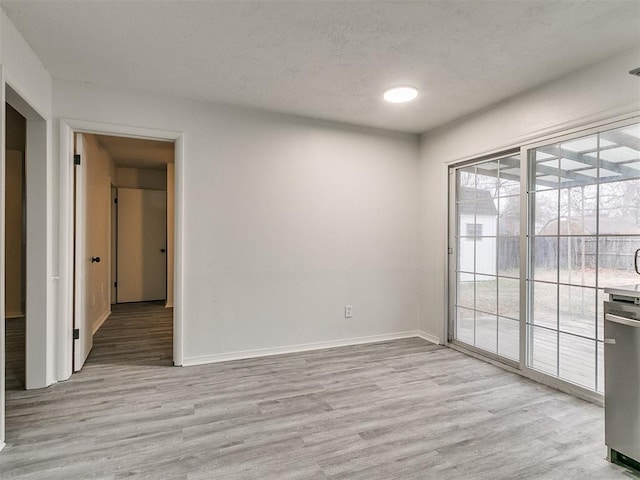 unfurnished room with light wood-type flooring