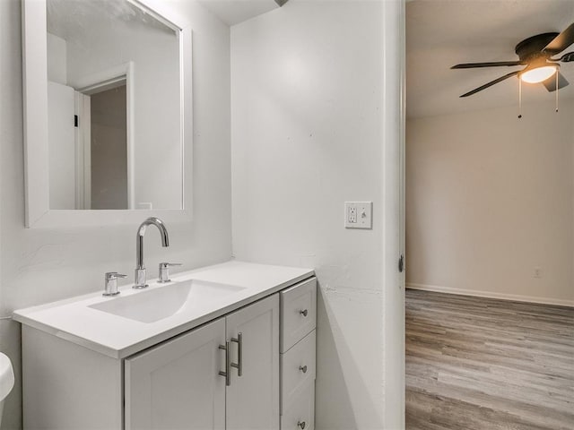 bathroom with vanity, ceiling fan, and wood-type flooring