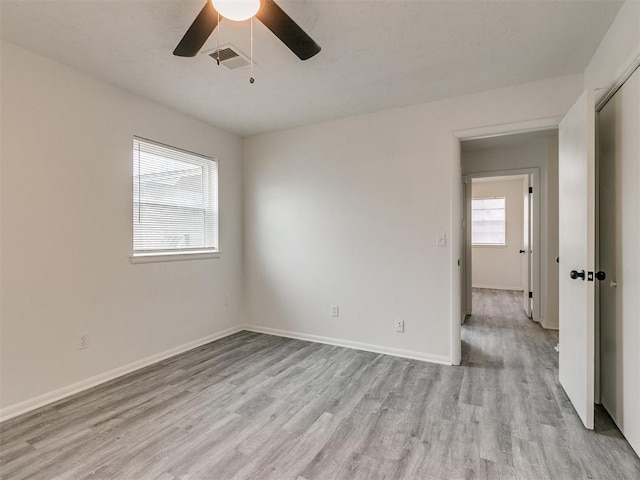 empty room with light hardwood / wood-style floors and ceiling fan