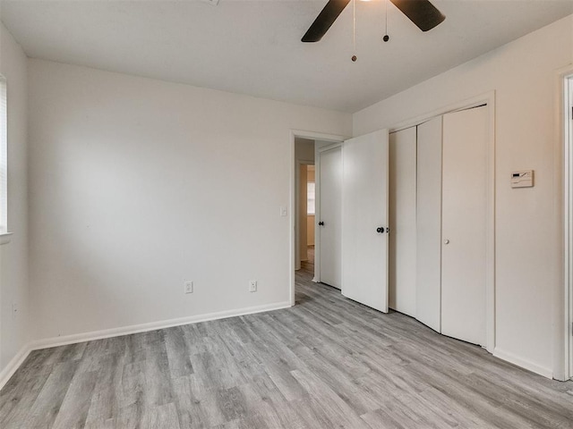 unfurnished bedroom featuring light wood-type flooring, a closet, and ceiling fan