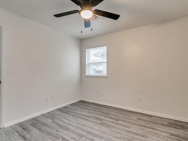 spare room featuring light wood-type flooring and ceiling fan