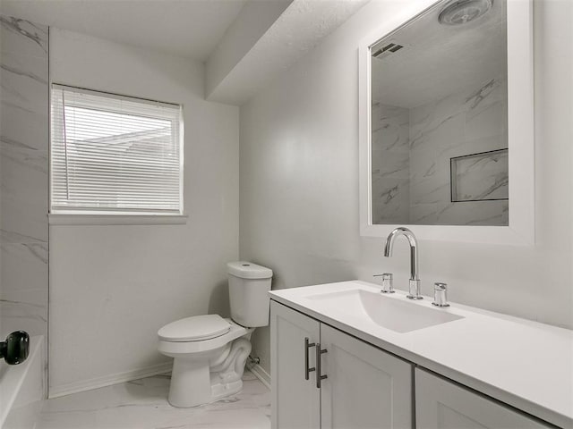 bathroom featuring vanity, toilet, and walk in shower