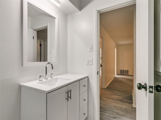 bathroom featuring hardwood / wood-style floors and vanity